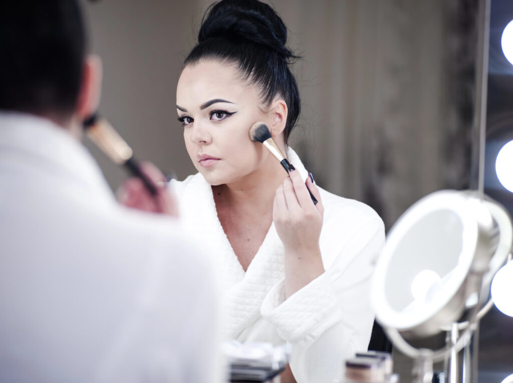 This image has an empty alt attribute; its file name is woman-putting-on-makeup-1024x764.jpeg